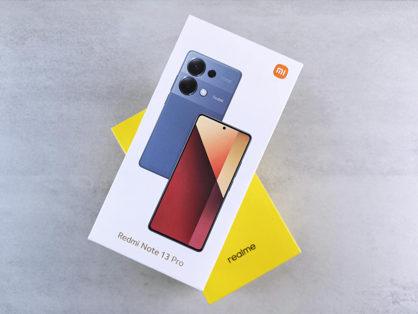 Close-up of Redmi Note 13 Pro phone box with sleek design on neutral background.